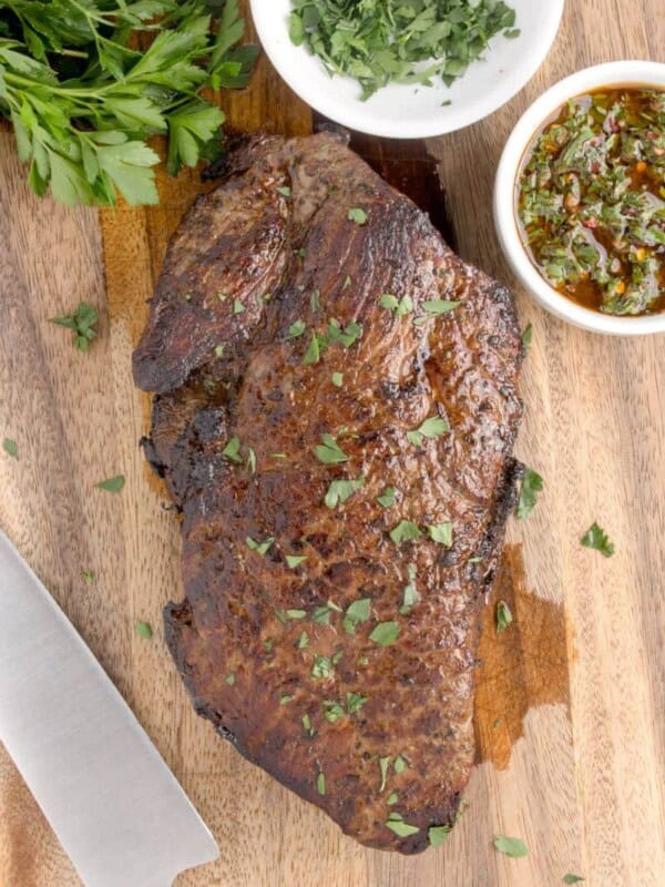 London broil made in oven, displayed on wood cutting board.