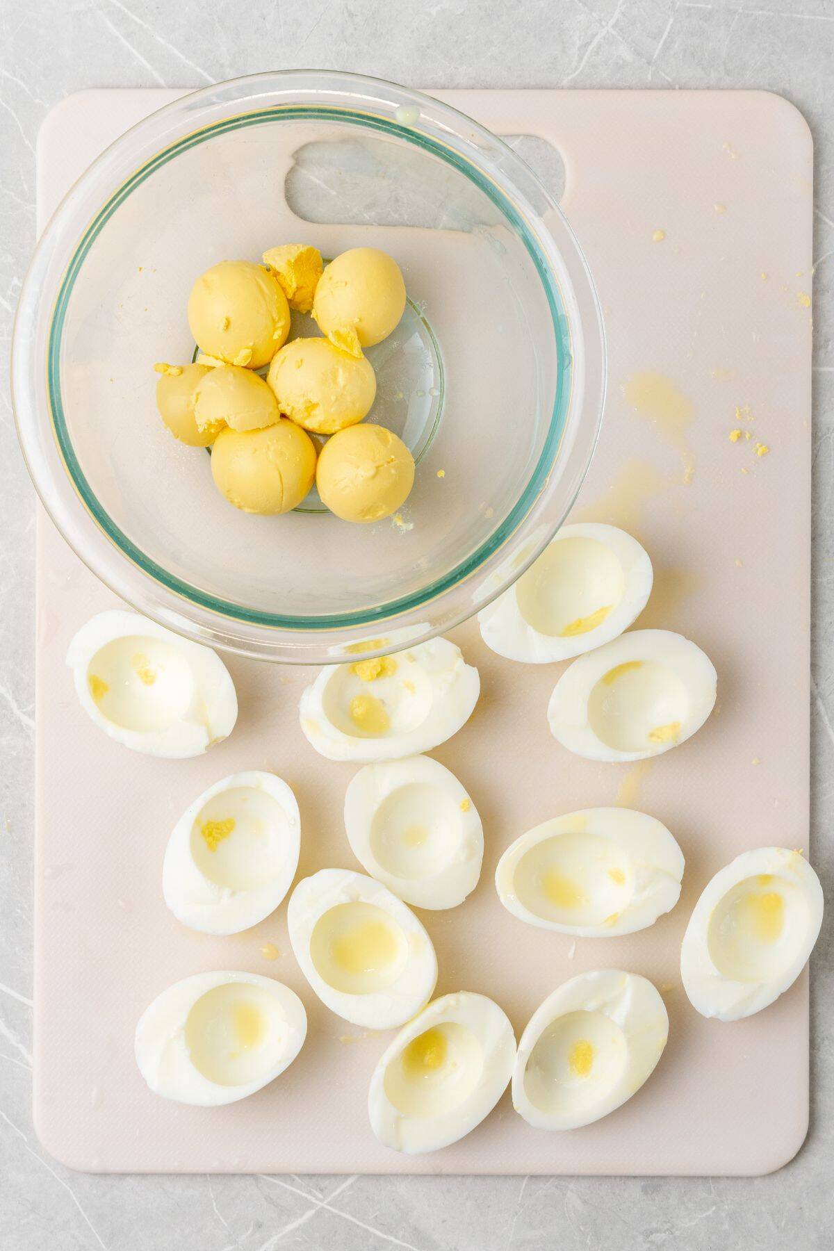 Yolks removed from the hard boiled eggs cut in half.