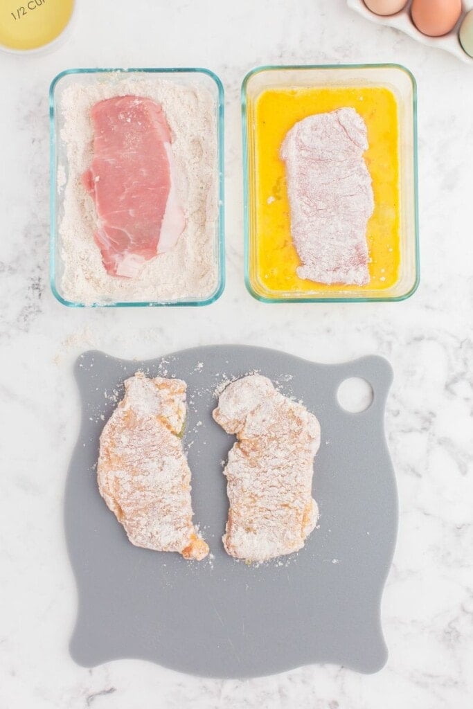 Battering pork chops for frying.