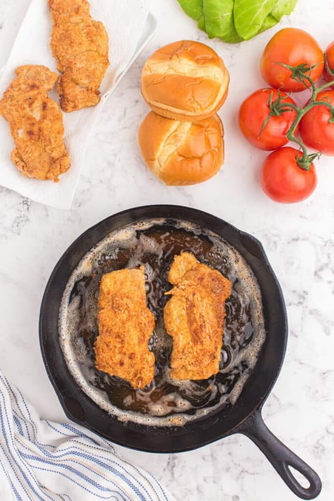 Golden fried pork chips in a pan.