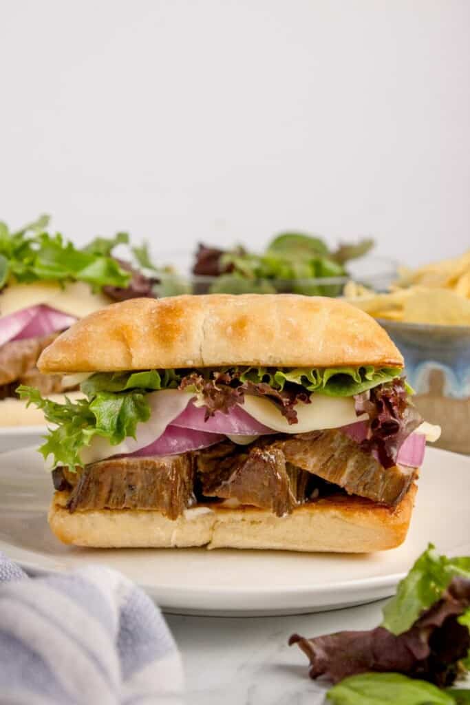 Close up of fully dressed beef roast sandwich.