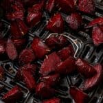 Close up of beets in an air fryer basket.