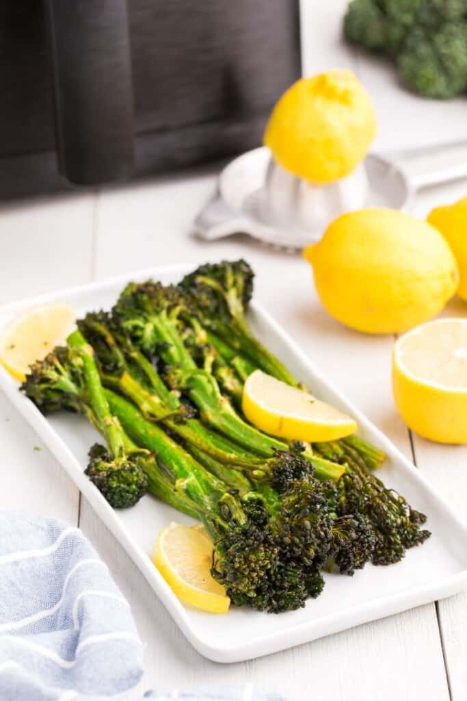 platter with lemon garnished broccolini