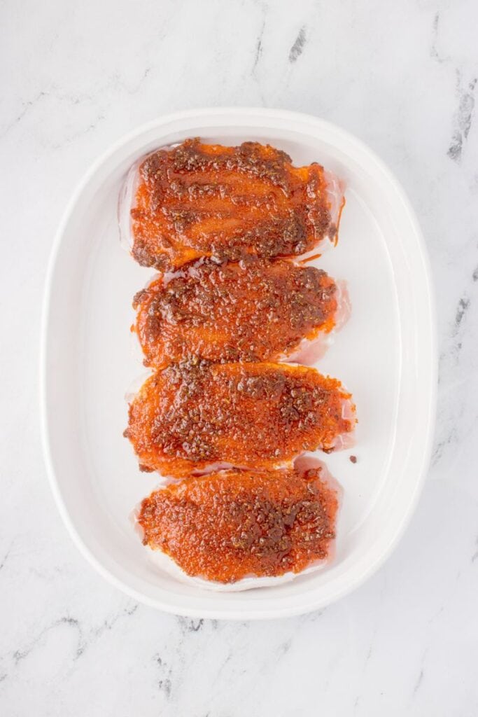 rubbing on homemade spice mix with olive oil onto pork chops