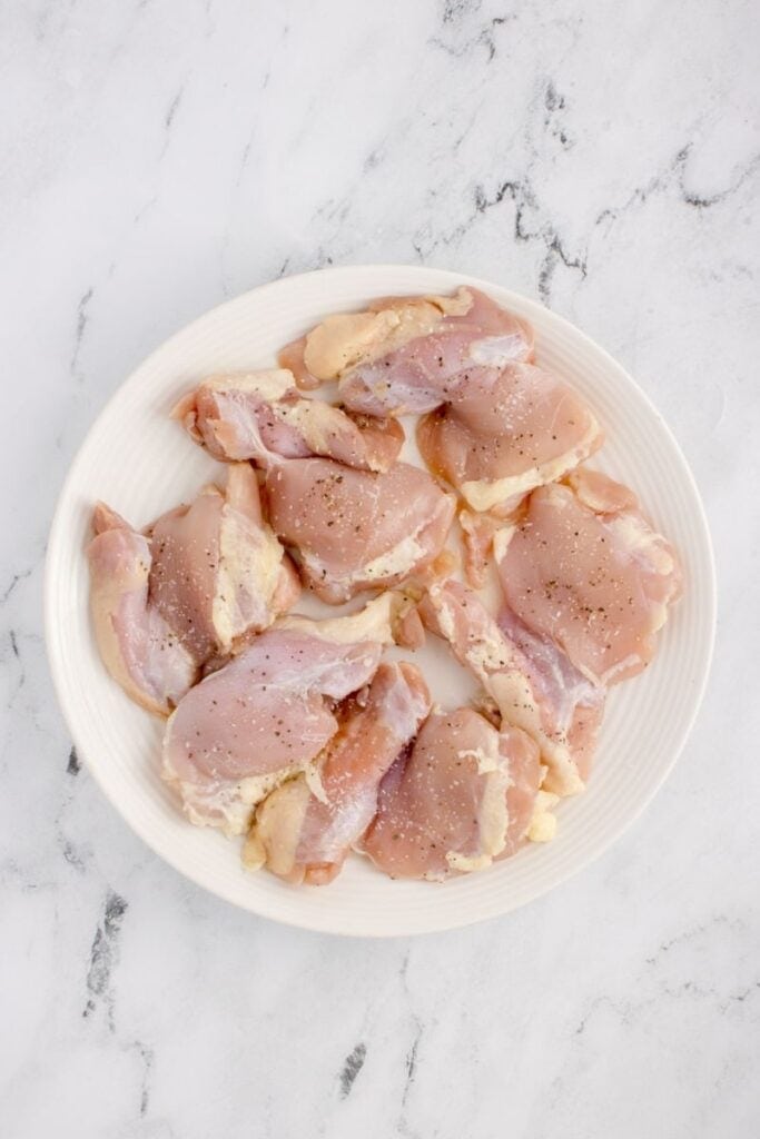 seasoning chicken thighs with salt and pepper
