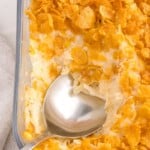 scooping up some cornflake casserole with a big spoon