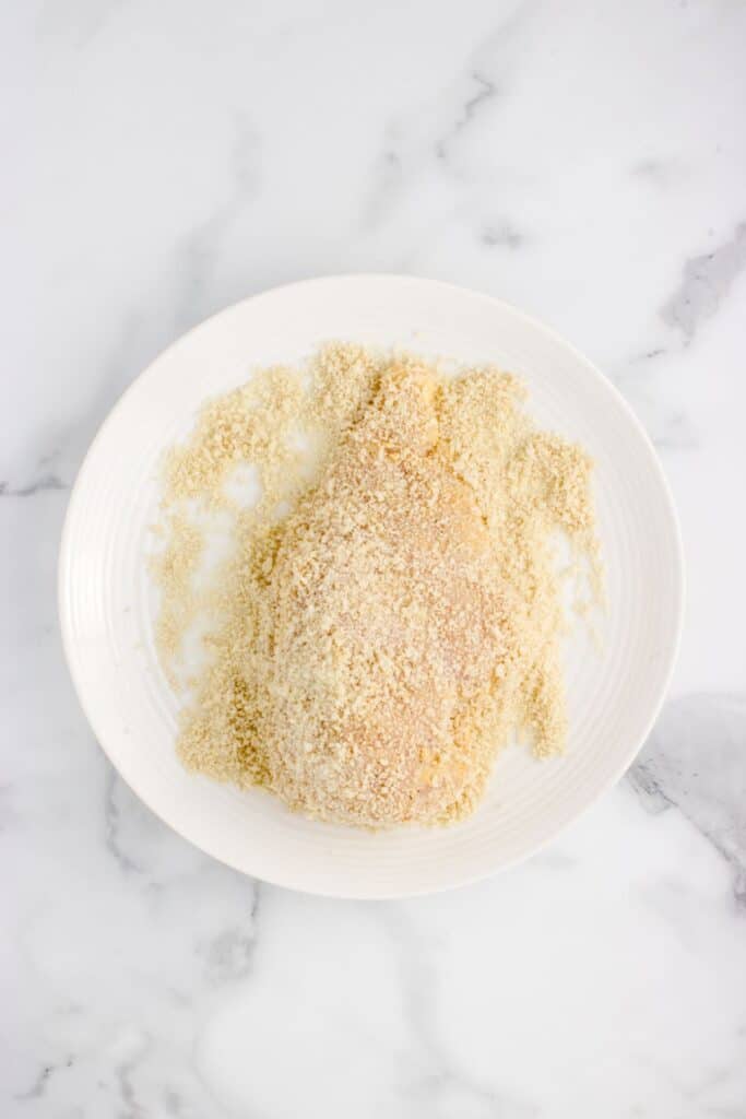 coating chicken in breadcrumbs