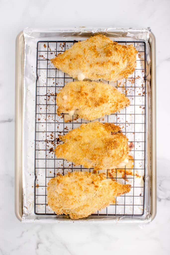 cooked chicken cordon bleu on a wire rack.