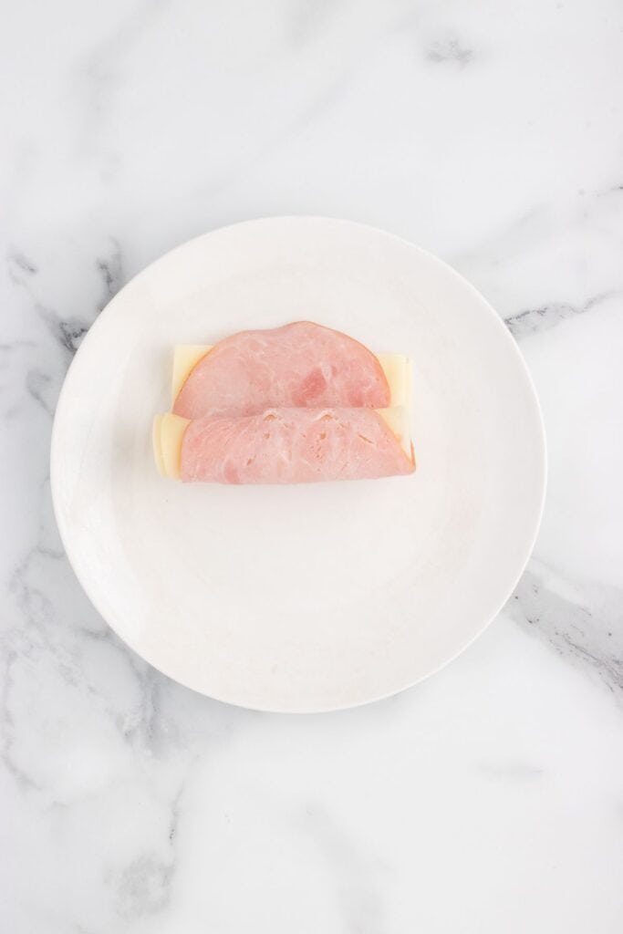 rolling swiss cheese and ham together