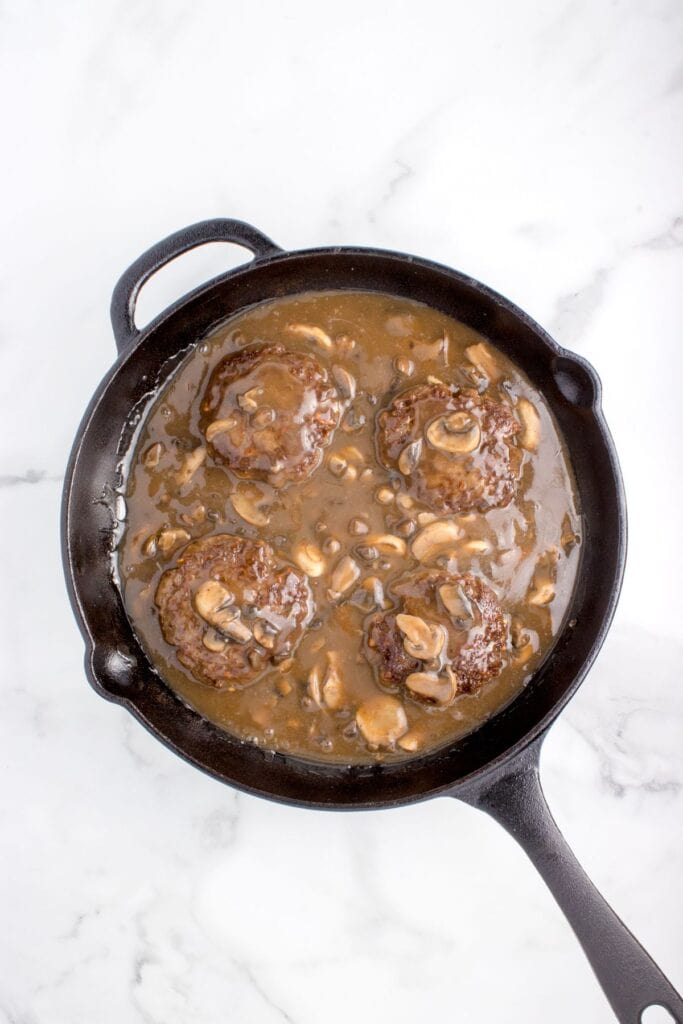 adding salisbury steak to mushroom gravy