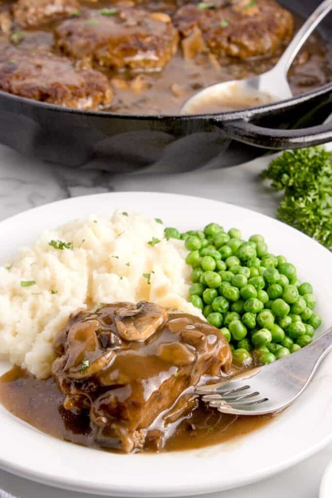 salisbury steak filet with potatoes and veggies on a plate