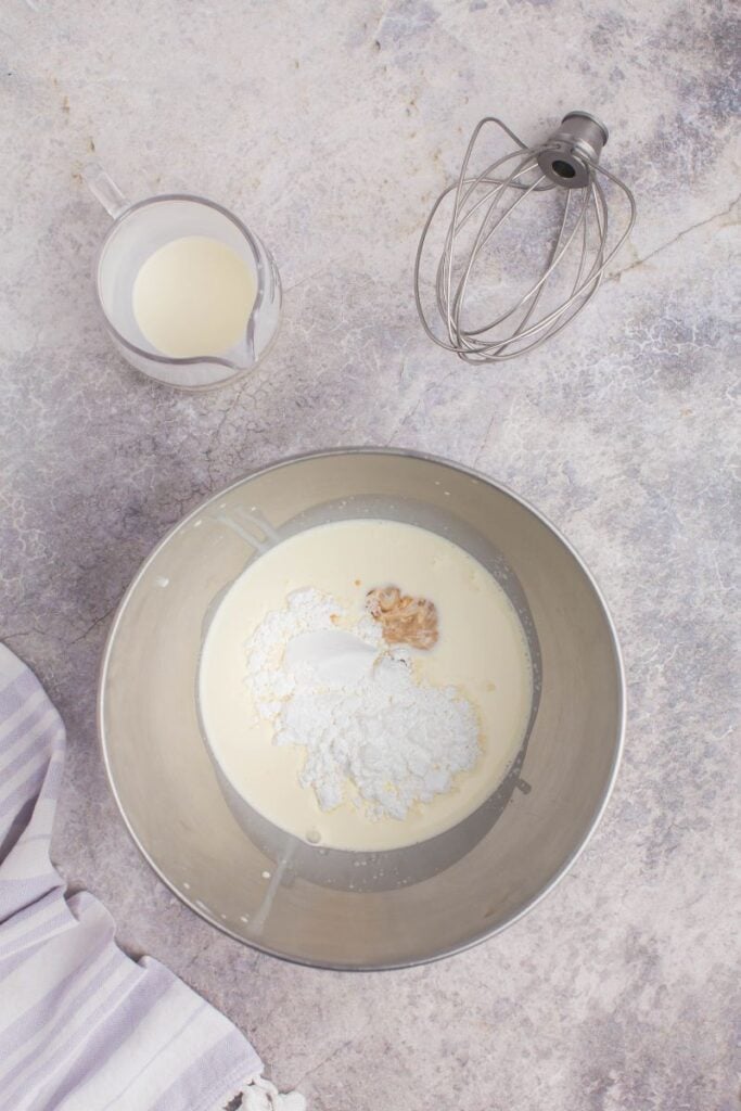 Mixing heavy cream with vanilla and sugar