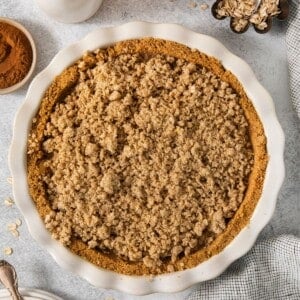 Finished apple pie graham cracker pie crust in the pie pan.