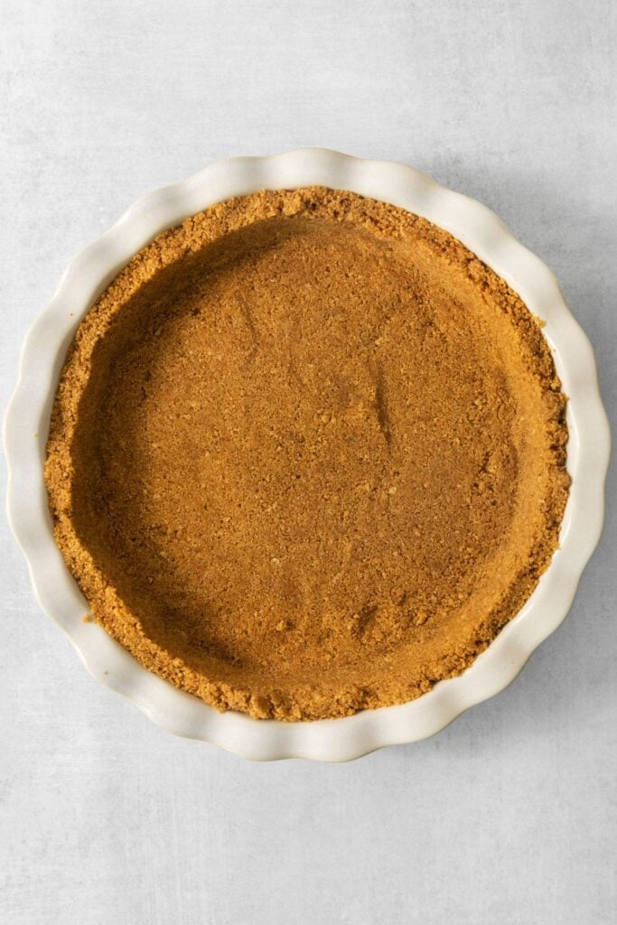 Graham cracker crust pressed into a pie plate.