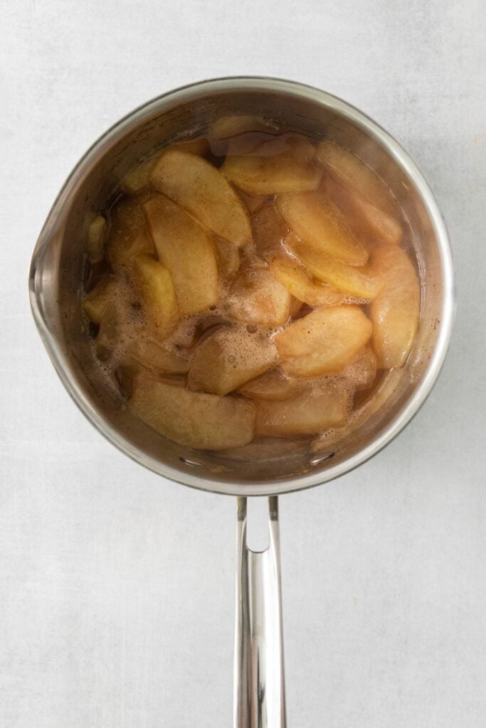 Apples and other seasonings for the apple layer in the pot showing the apples as fork-tender.
