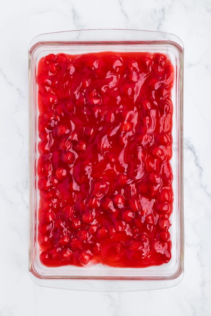 pour cherry pie filling into a baked pan