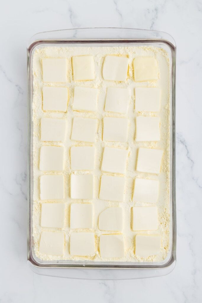 adding sliced butter over cake mix layer