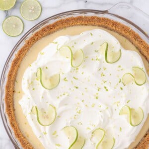 homemade key lime pie with whipped cream and lime zest