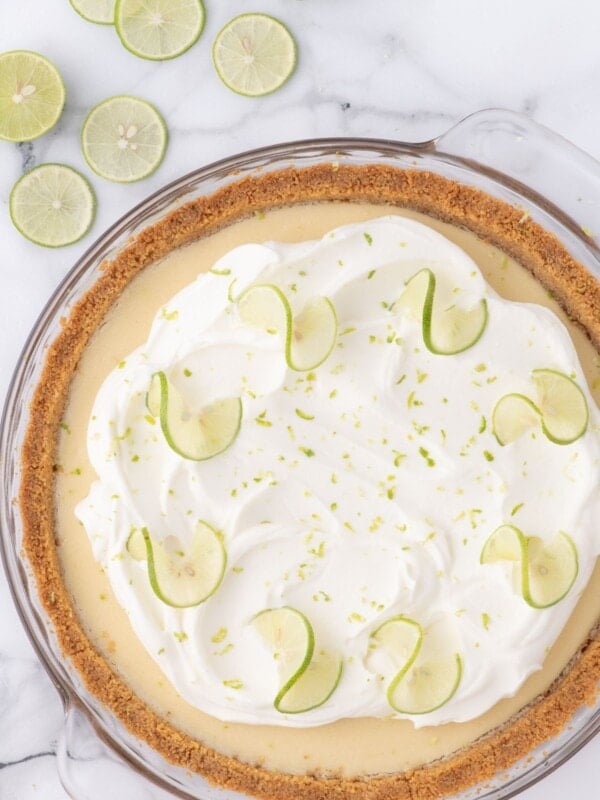 homemade key lime pie with whipped cream and lime zest