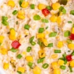 Close up of the corn dip with fritos in a serving bowl.