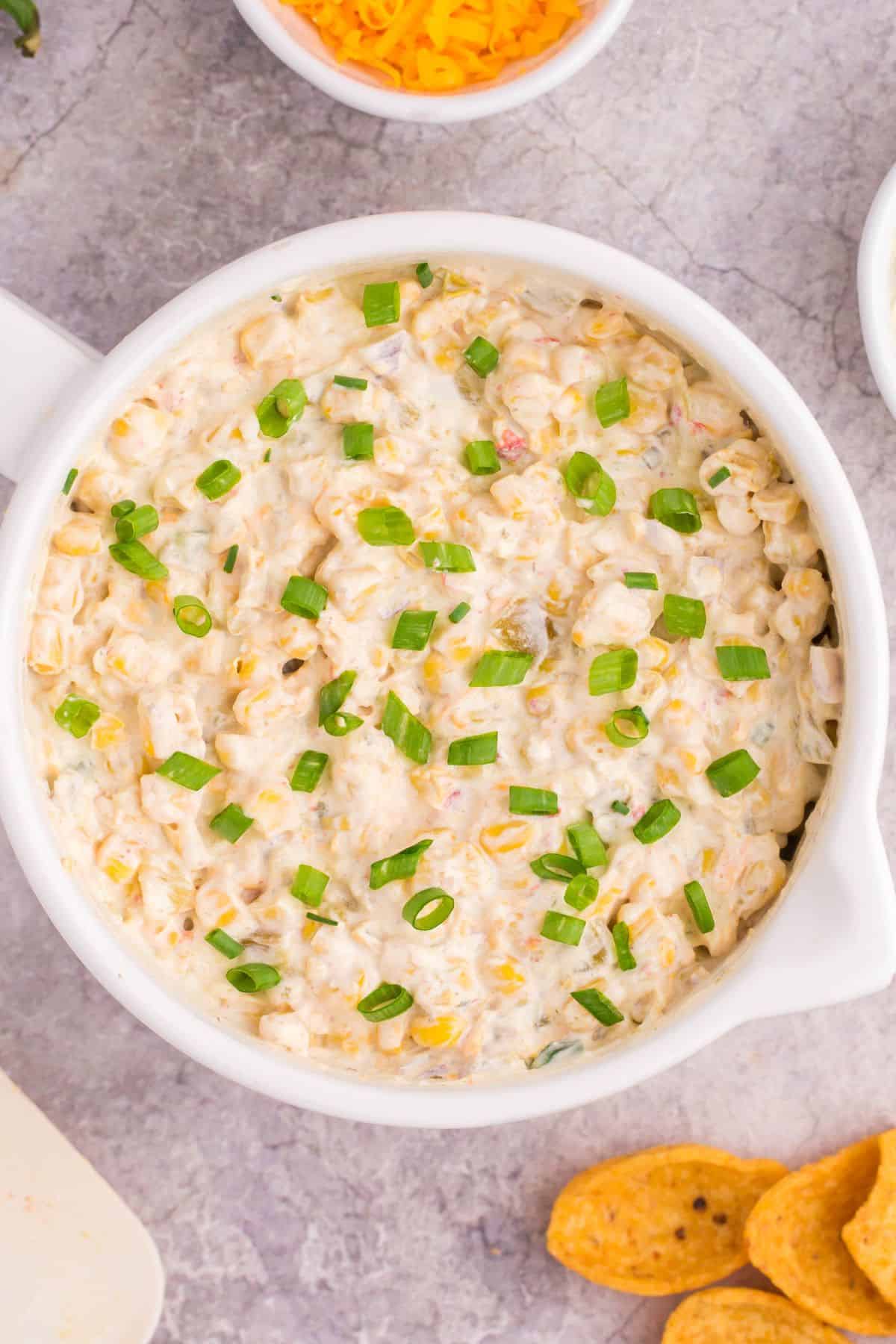 The fiesta corn mixed into the corn dip then topped with more green onions.