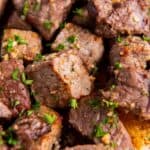 Close up of the cooked air fryer steak bites covered in garlic butter.