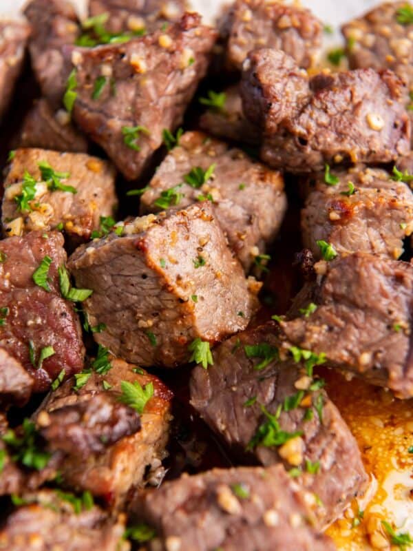 Close up of the cooked air fryer steak bites covered in garlic butter.