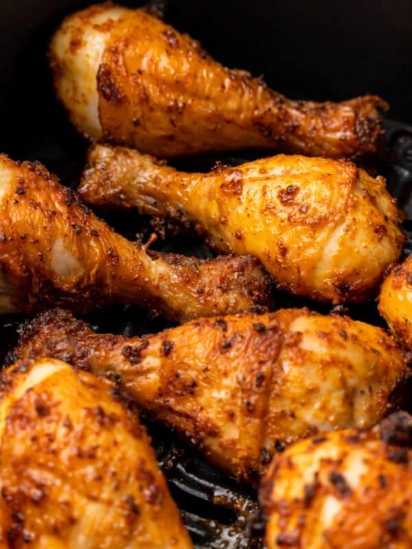 Closeup of the chicken legs in the air fryer basket all done air frying.