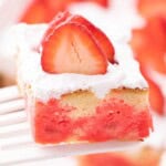 Close up view of a slice of jello poke cake to see the jello inside the cake.