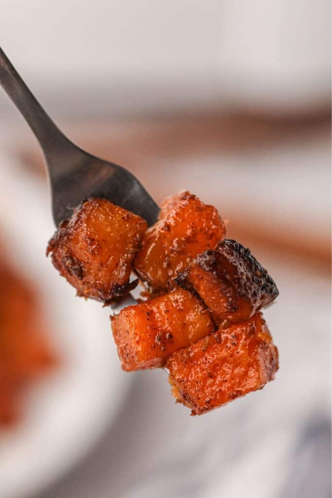 Close up of air fried butternut squash on a fork.