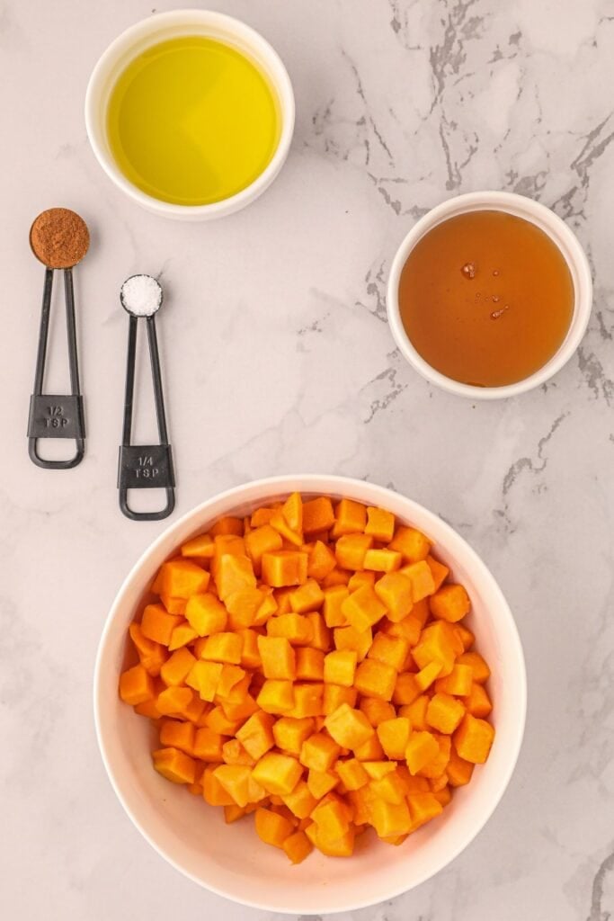 Ingredients needed to make air fryer butternut squash: butternut squash, oil, cinnamon, and sea salt.
