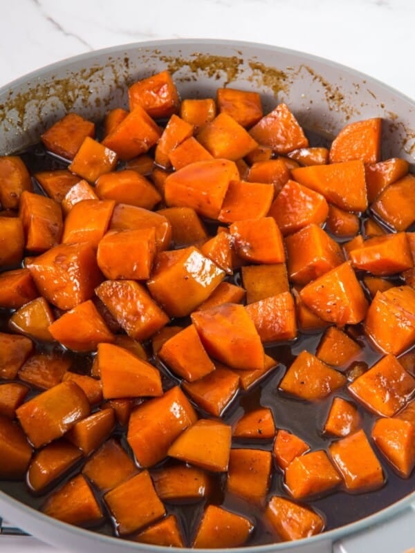 Candied yams in a skillet on the stove.