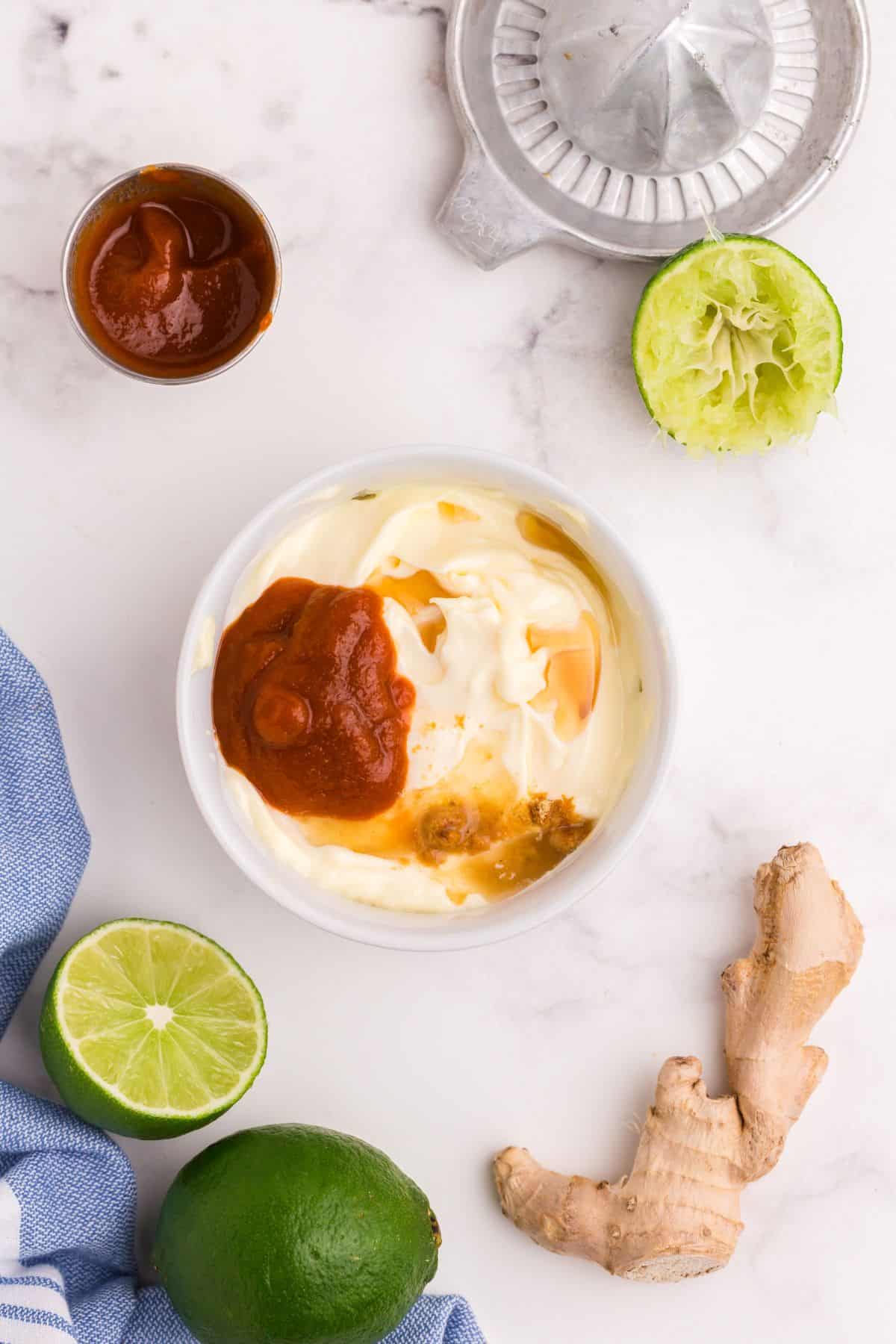 Spicy mayo recipe ingredients about to be mixed in a bowl.