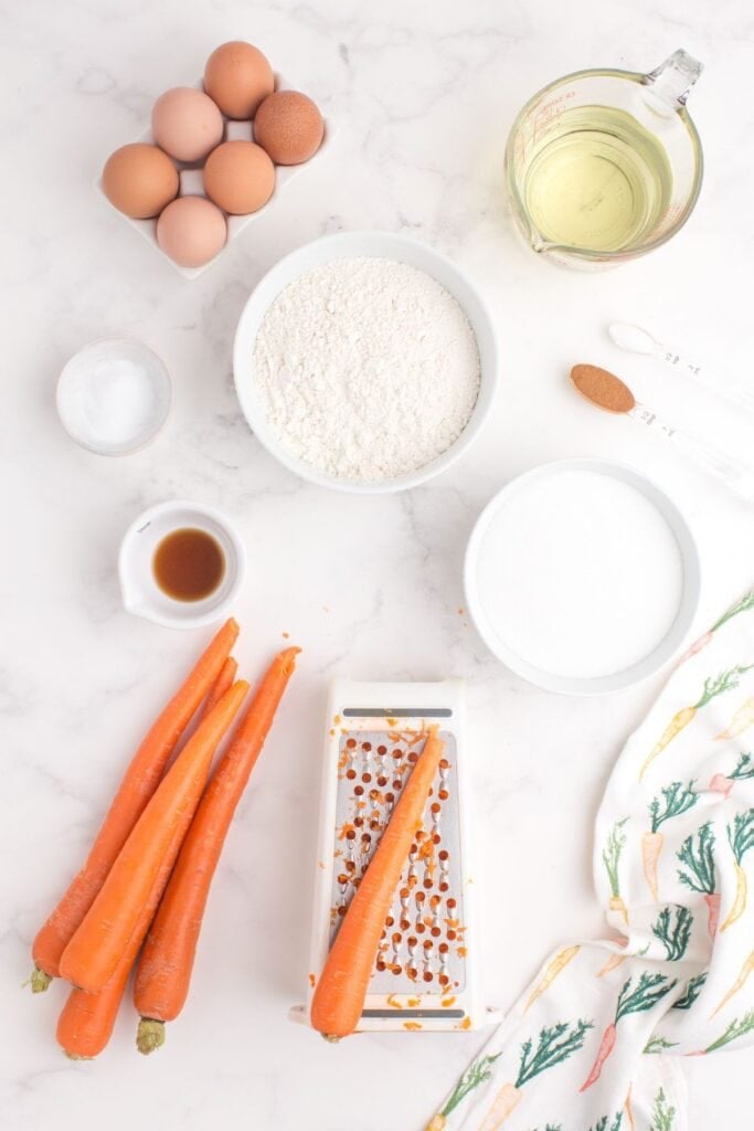 Ingredients for carrot cake: all-purpose flour, sugar, baking soda, vegetable oil , eggs , grated carrots, vanilla, cinnamon, salt and cream cheese frosting.