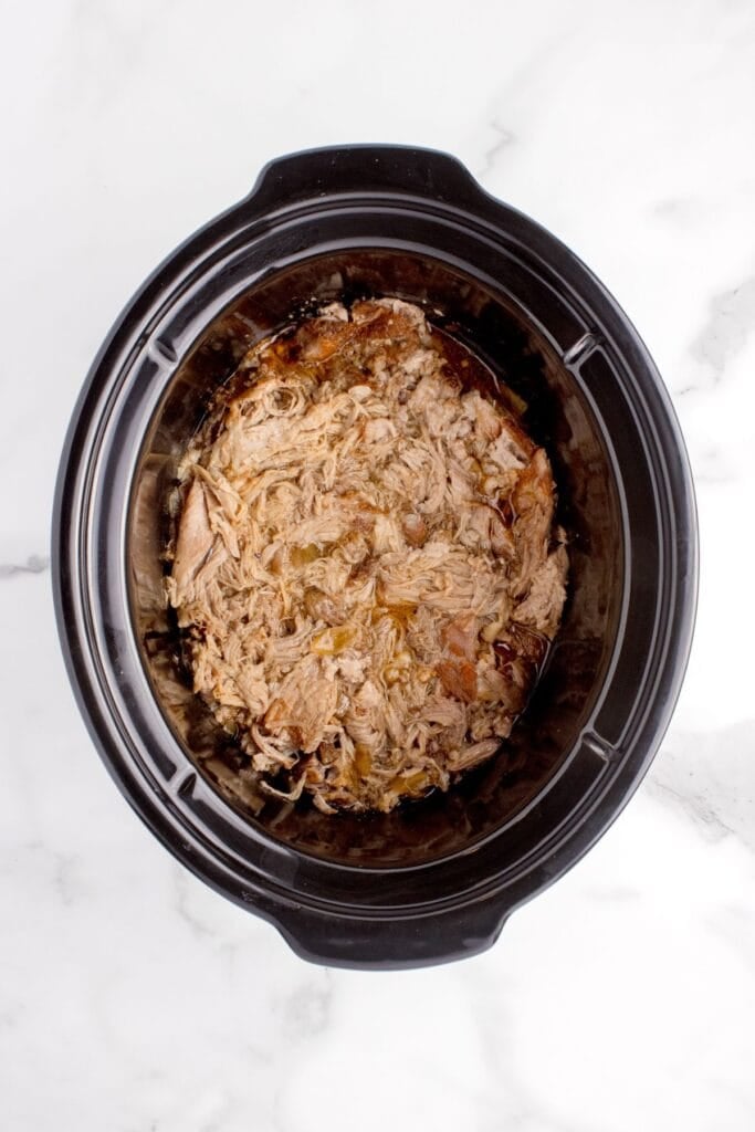 Pulled pork in a crock pot insert.