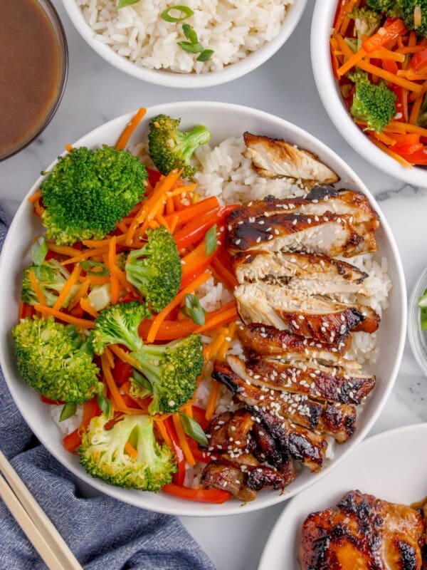 Completed chicken teriyaki bowl with white rice, chicken, peppers, carrots, and broccoli.