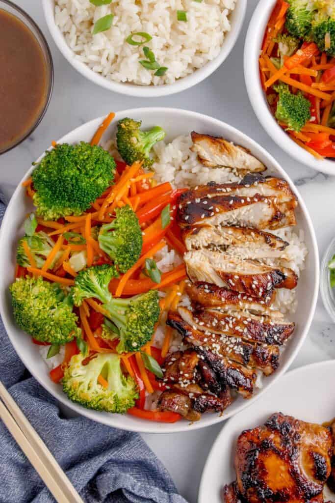 Completed chicken teriyaki bowl with white rice, chicken, peppers, carrots, and broccoli.