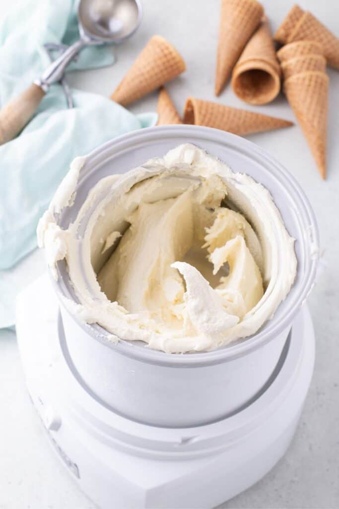 Ice cream maker with homemade vanilla ice cream in it.
