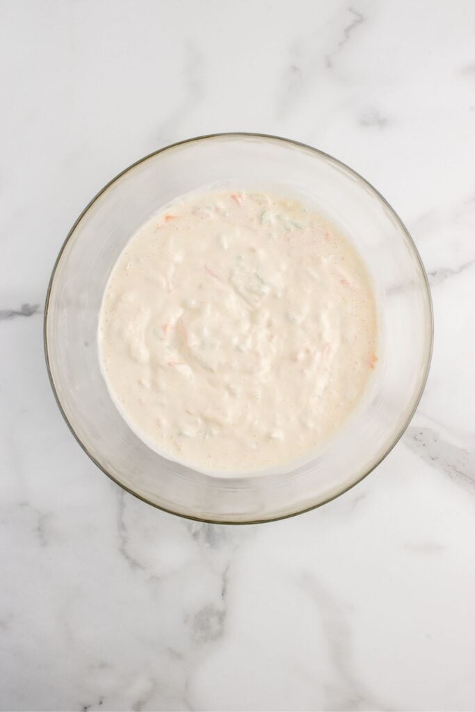 Creamy sauce for macaroni salad in a glass bowl.