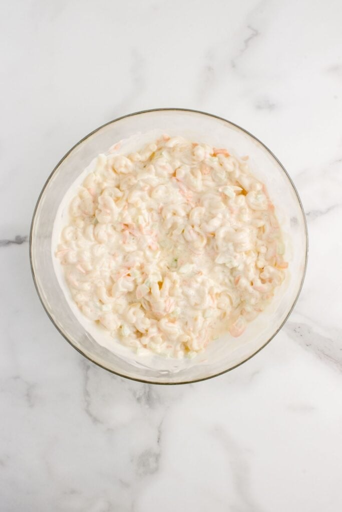 Glass bowl of combined macaroni salad.