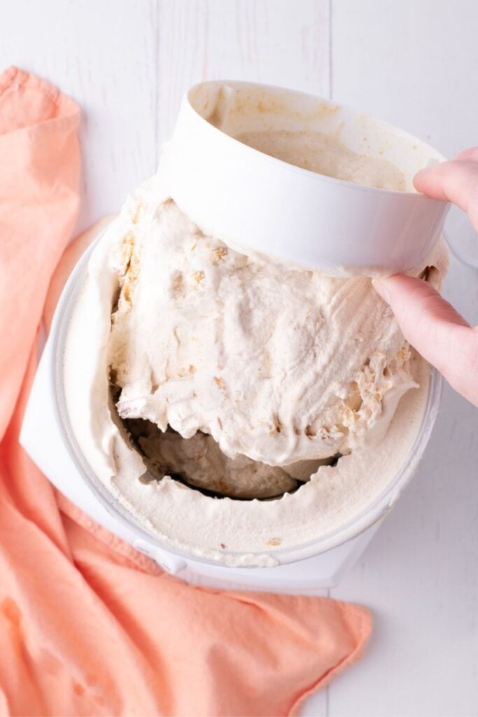 The paddle insert is being removed from the churned ice cream.