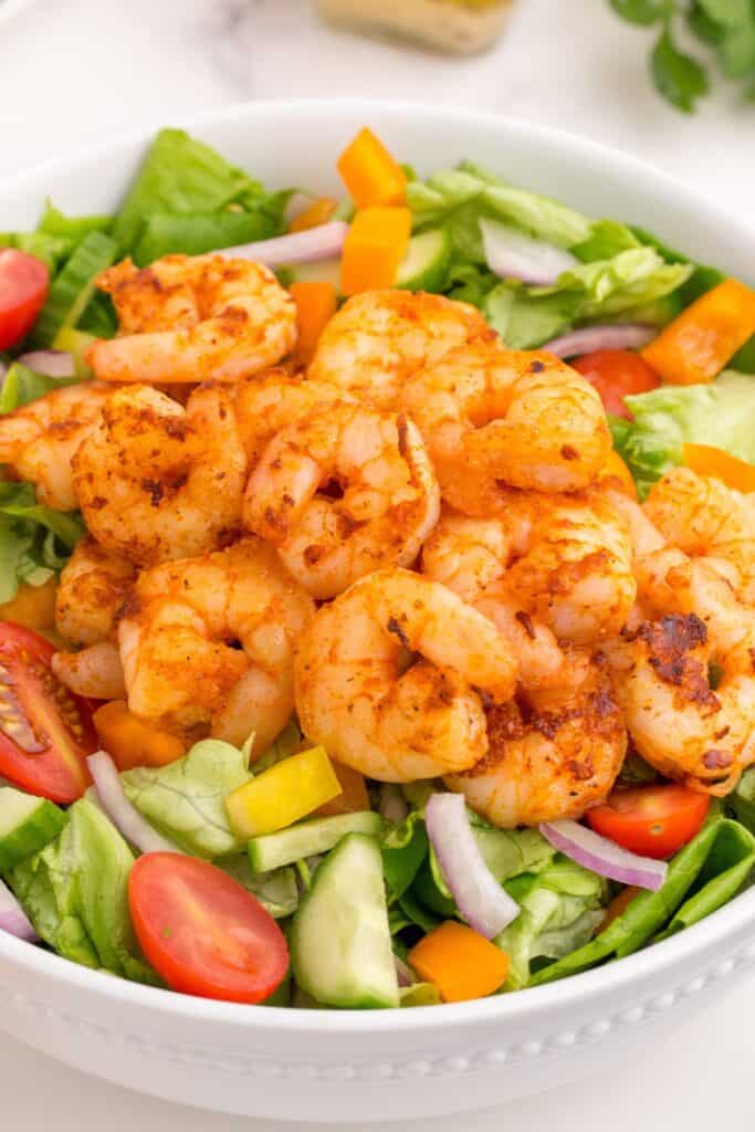 Completed shrimp salad in a white serving bowl.