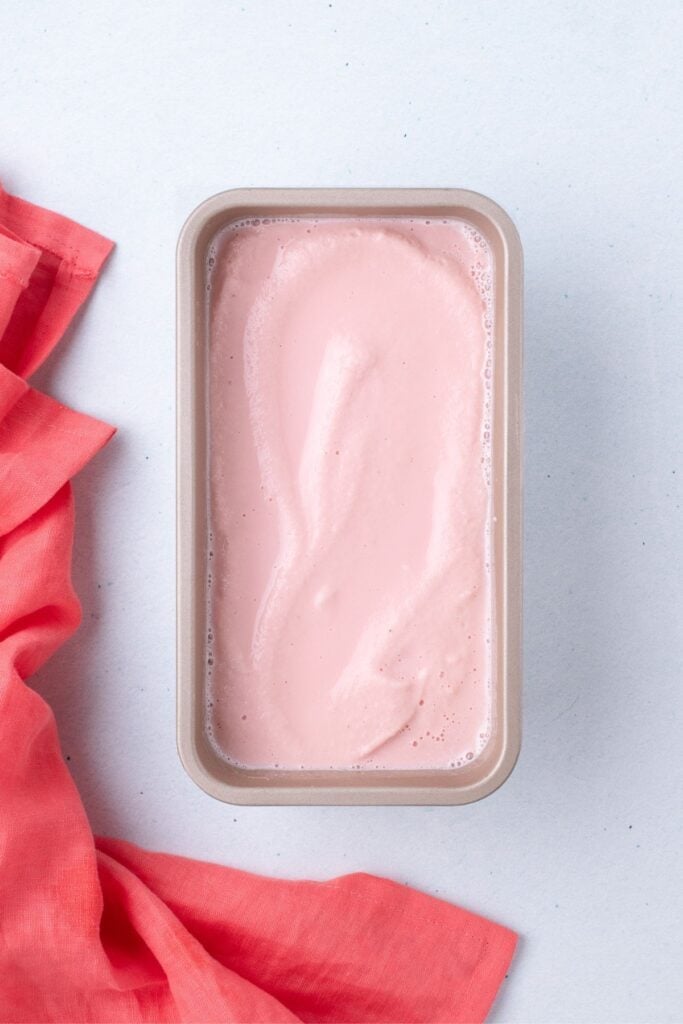 Pan of watermelon ice cream base in a pan.