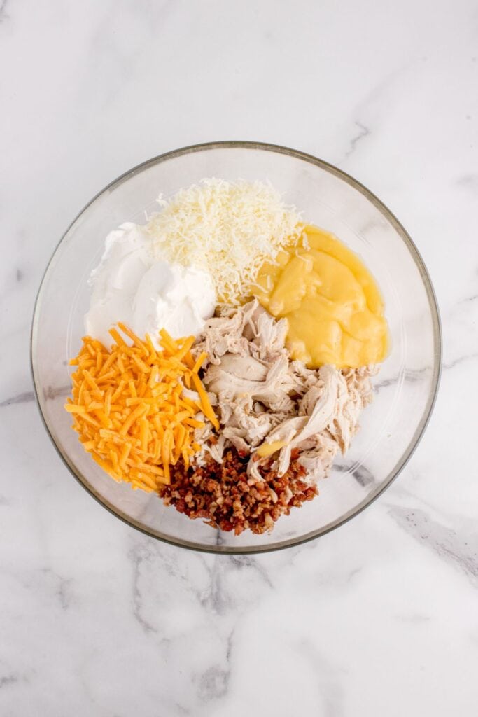 Ingredients for chicken layer in a glass bowl.