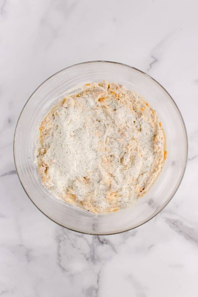 Ranch seasoning packet sprinkled on top of the chicken mixture for tater tot casserole.