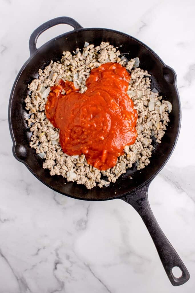 Marinara sauce added to the cooked ground turkey and onions.
