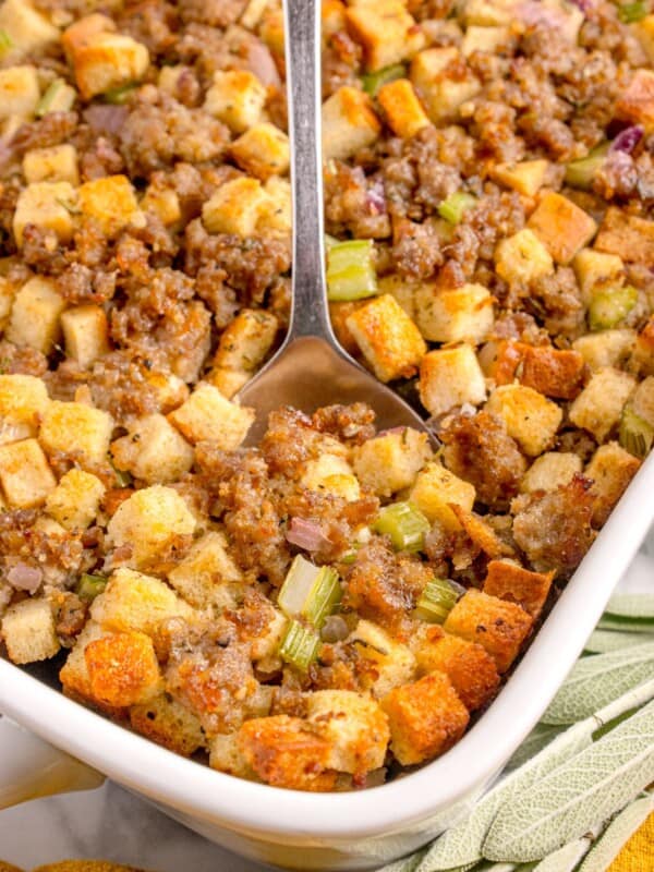 A white baking dish with completed sage and sausage stuffing in it.