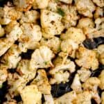 Close up of crispy cauliflower in an air fryer basket.