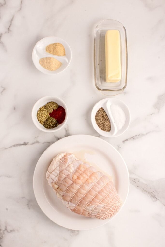 Ingredients for Boneless Turkey Breast: boneless turkey breast, butter, dried rosemary, dried thyme, dried sage, garlic powder, smoked paprika, salt, and black pepper.