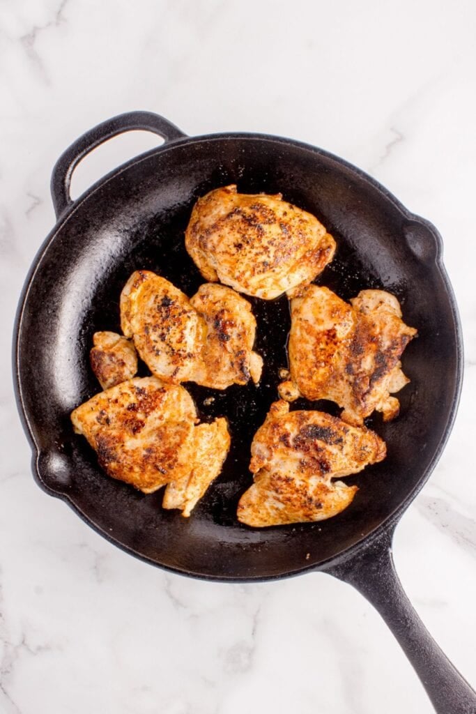 Chicken thighs cooked in cast iron skillet.